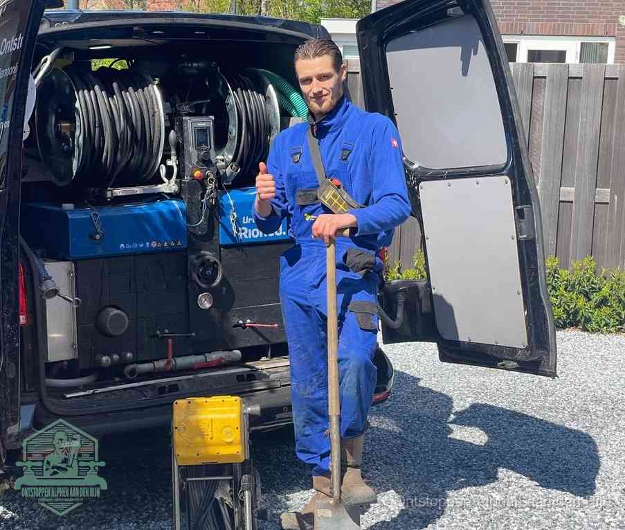 Een tevreden monteur met opgestoken duim naast de bestelbus, slim ingrijpen bespaart kosten bij een verstopte afvoer in Alphen aan den Rijn